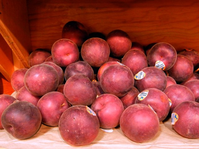 Black velvet apricots, a dark-purple, velvet-textured variety of apricot, with produce stickers