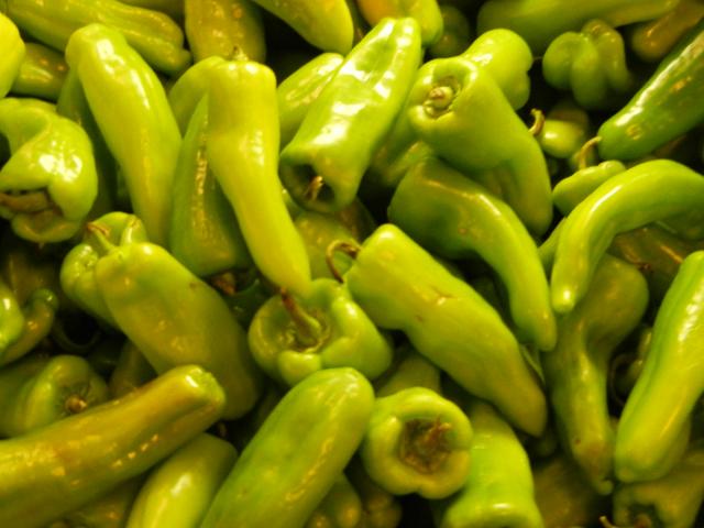 Green cubanelle peppers, light green in color, longer than bell peppers, with a rounded end