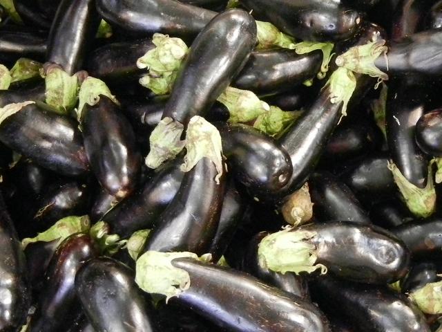 Large eggplant, a shiny purplish black color, with a small light green top