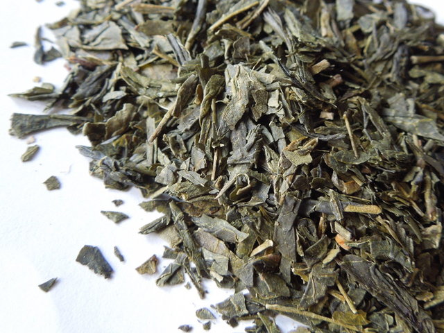 Closeup of green tea broken into small flake-like pieces