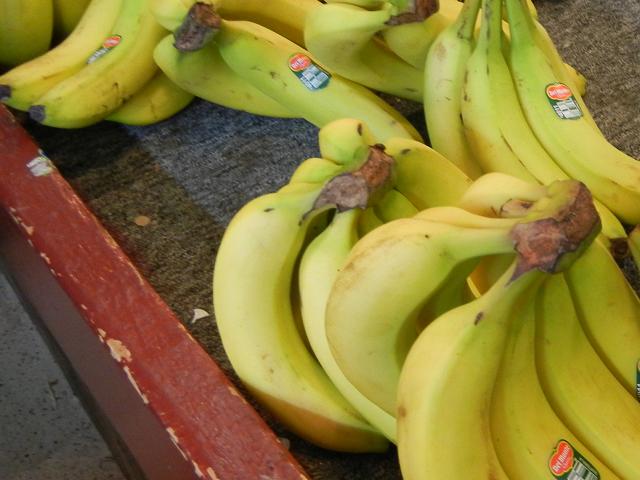 Bunches of ripe yellow bananas, bearing the Del Monte brand name