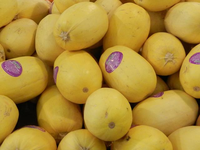 Big, oval-shaped, yellow squash, some with purple stickers on them