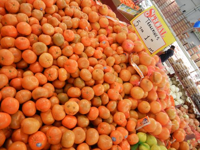 Lots of tangerines, most intense orange, some greenish and a few with bruises