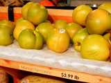 Mango nectarines, green-yellow nectarines, on a shelf with a sign reading: Mango Nectarine - $3.99 lb
