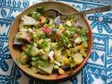 A bowl with a colorful salad containing numerous finely-chopped things