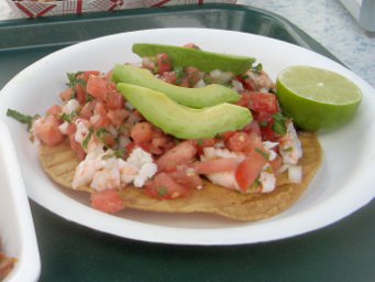 Shrimp cevice tostada with avocado slices