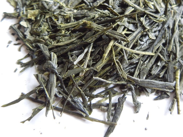 Closeup of loose-leaf sencha, a green tea with straight, thin leaves