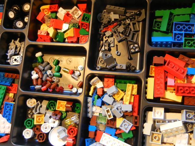 A box of diverse Lego bricks in different compartments