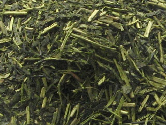 Kukicha, green tea made from stems and twigs, showing pale green stems, and some darker green leaves
