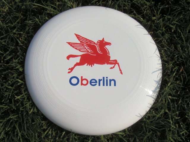 White frisbee with a logo resembling Mobil pegasus, but with a cow's udder, and the name Oberlin written in the style of the logo