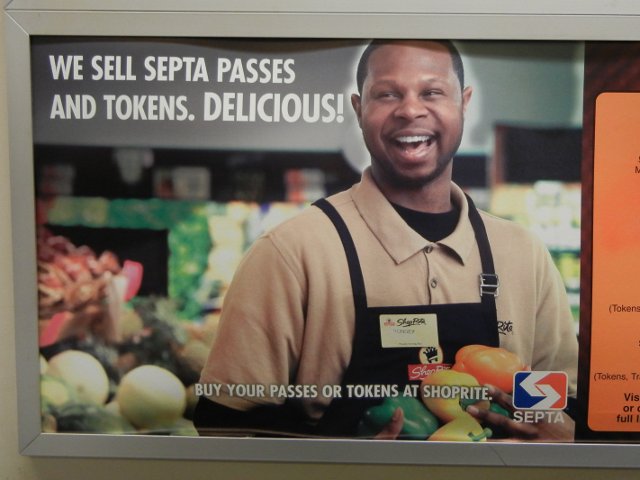 An advertisement showing a supermarket and employee, saying: WE SELL SEPTA PASSES AND TOKENS.  DELICIOUS!  Buy your passes or tokens at Shoprite.