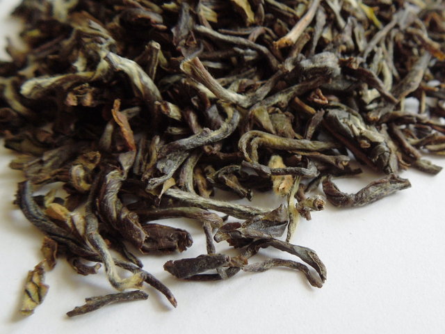 Closeup of high-grade black tea showing twisted leaves with a greenish color and some downy hairs