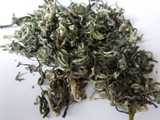 Loose-leaf green tea with silvery buds, curled into squiggly, almost snail-like shapes
