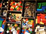 A box of diverse Lego bricks in different compartments