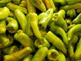 Green cubanelle peppers, light green in color, longer than bell peppers, with a rounded end