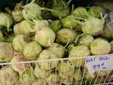 Kohlrabi, a round, greenish vegetable, in a bin, marked: Kohl Rabi, 99 cents -lb-