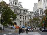 Philadelphia's city hall viewed from a distance, with protesters and tents in front