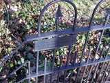 Plaque in an iron fence, reading: on this site in 1897 nothing happened. 