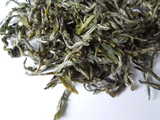 Loose-leaf tea showing downy white hairs on buds, and twisted, yellow-green leaves