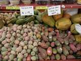 Xoconostle, small cactus pears on the left, pale pink and greenish, and larger, regular cactus pears on the right, rich reddish and deeper green